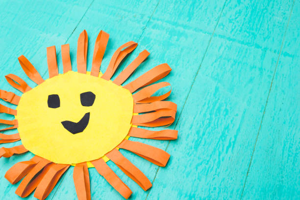 istock Children's handmade from colored paper - the sun with a smile 959673266