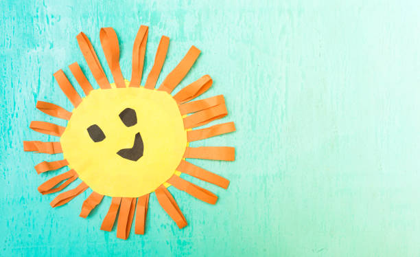 istock Children's handmade from colored paper - the sun with a smile 959673324