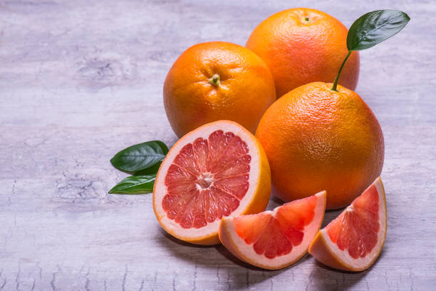 istock Grapefruit whole, half and slice, green leaf, juicy ripe isolated on a gray background 959673482
