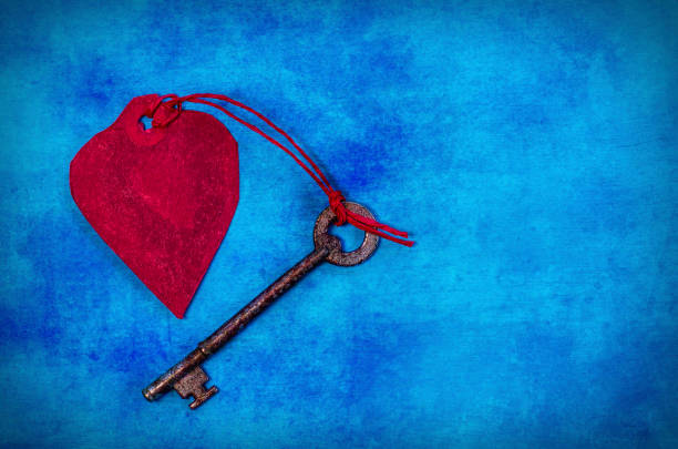istock Red Paper Heart and an old key with copy space 959678062