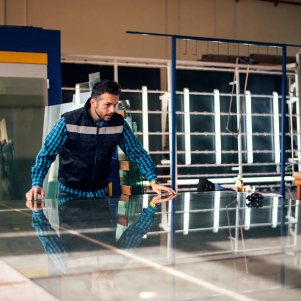 istock Worker handling glass sheet in warehouse 959682224