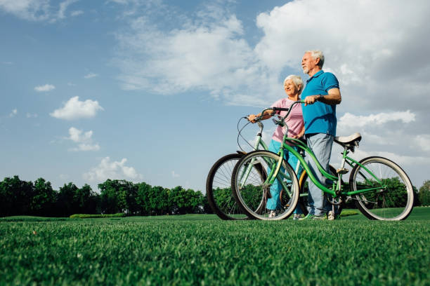 istock Senior couple with their bikes in park, side view 959682726