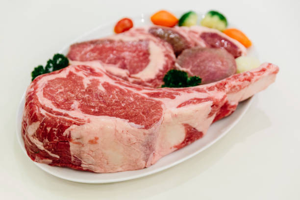istock Different types of raw beef with fresh herbs and vegetables on the table for customer selection. 959685782