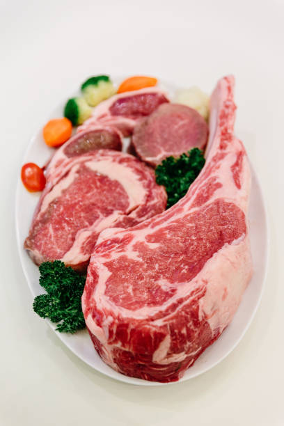 istock Different types of raw beef with fresh herbs and vegetables on the table for customer selection. 959685864