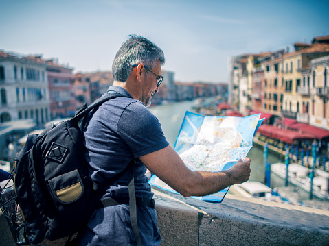 Tourist man with map in Venice- Italy
