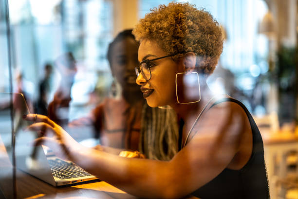 istock Two Business woman meeting through window 959694398