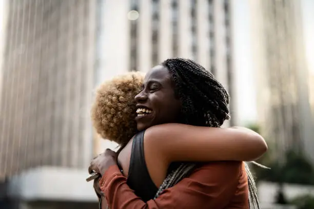 Photo of Business woman/students embracing