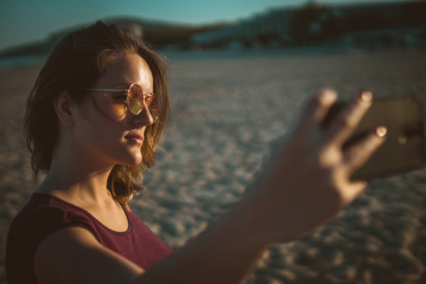 istock Woman taking selfie on the beach 959698610