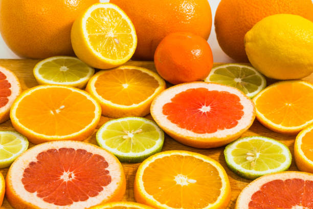 istock Citrus fruit background with sliced f oranges lemons lime tangerines and grapefruit 959704644