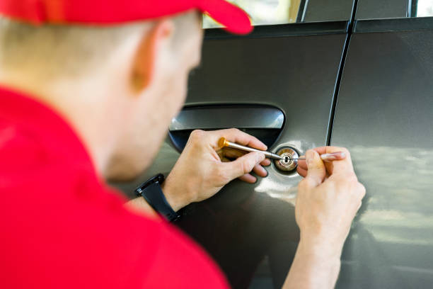 locksmith opening car door with lockpicker locksmith opening car door with lockpicker car door photos stock pictures, royalty-free photos & images