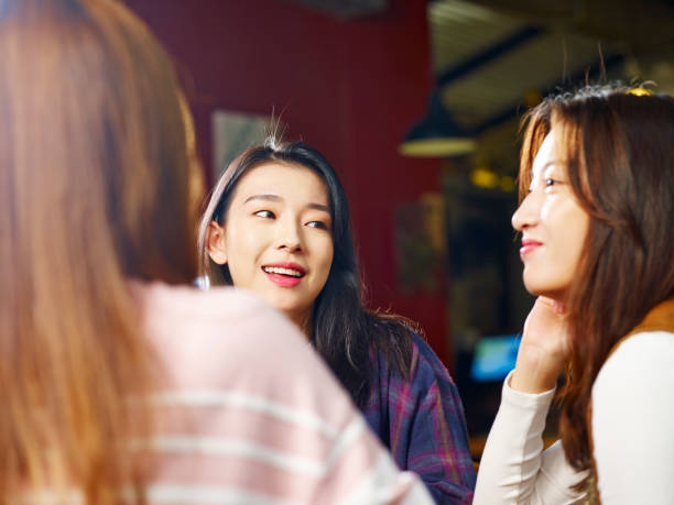 young asian women chatting in coffee shop - chinese ethnicity student china asian ethnicity imagens e fotografias de stock