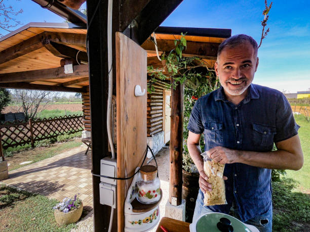 istock Smiling Mature Man Cooking in Outdoor Kitchen 959708770