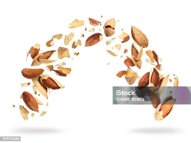 Almonds Crushed Into Pieces Frozen In The Air On A White Background Stock Photo - Download Image Now