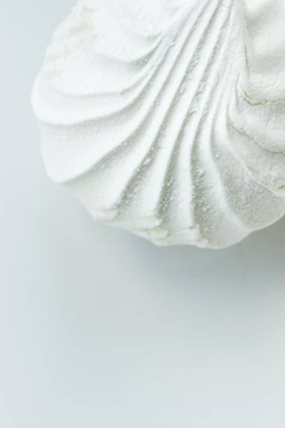 istock Big White Sea Shell Shaped Marshmallow. Elegant Styled Stock Image for Blogs Social Media. Monochrome. Baking Fashion Poster Banner Streamer Template. Copy Space 959720578