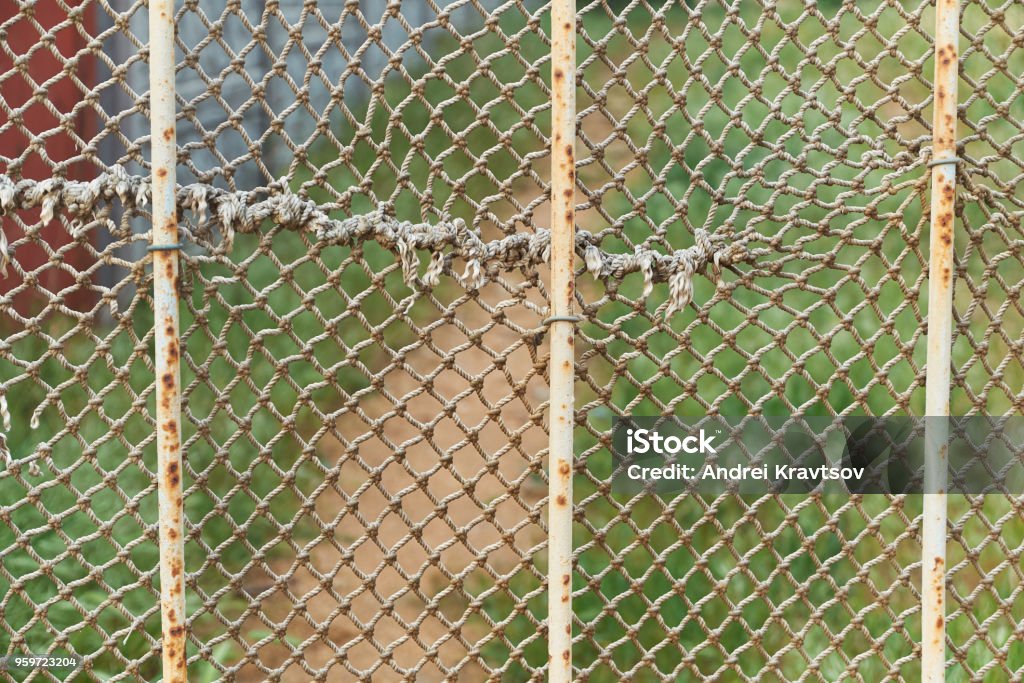 Ragged Rope Net Is On The Rusty Iron Fence Stock Photo - Download Image Now  - Abandoned, Abstract, Animal Markings - iStock