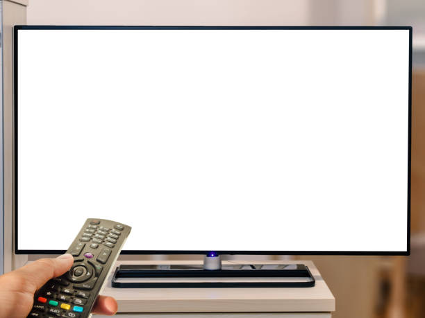 istock watching television with remote control at home. Blank tv screen 959724566