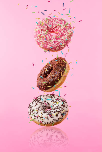 istock Flying sweet donuts isolated on pink background. 959724824