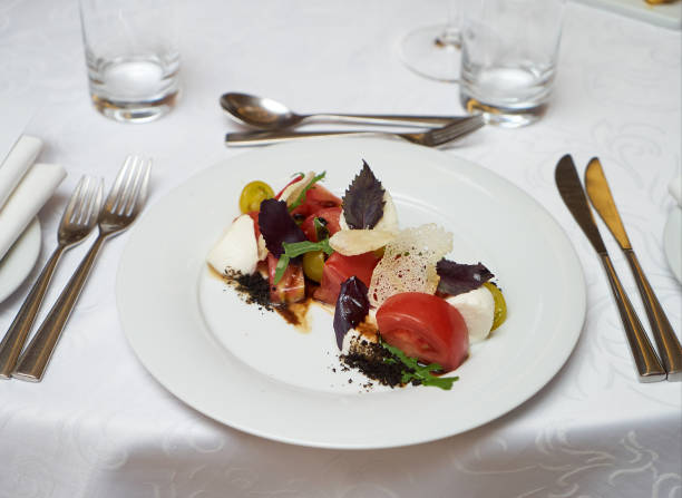istock Vegetarian food with marinated tomatoes, arugula, mozzarella che 959737420