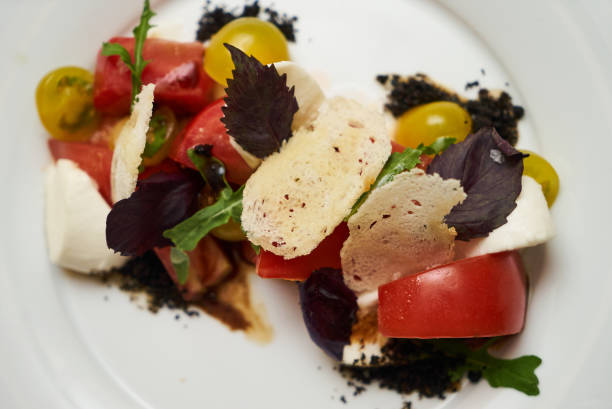 istock Vegetarian food with marinated tomatoes, arugula, mozzarella che 959737618