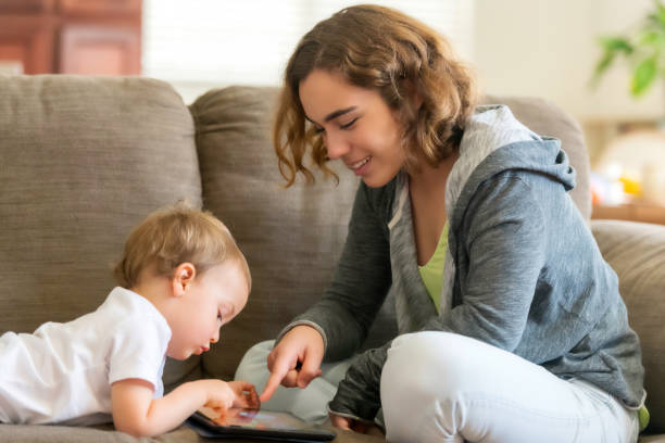 mother and son (could be a babysitter and child) - nanny imagens e fotografias de stock