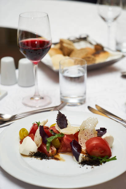 istock Vegetarian food with marinated tomatoes, arugula, mozzarella che 959740460