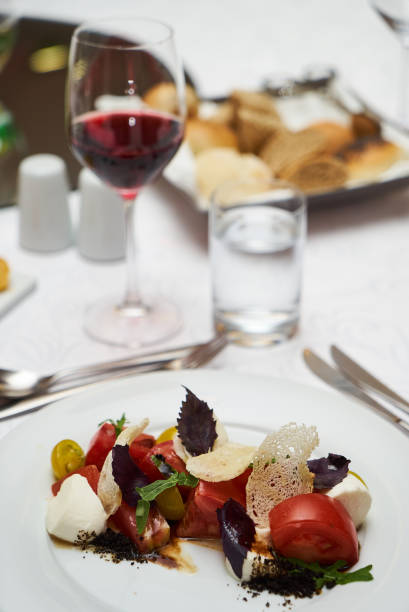 istock Vegetarian food with marinated tomatoes, arugula, mozzarella che 959740556