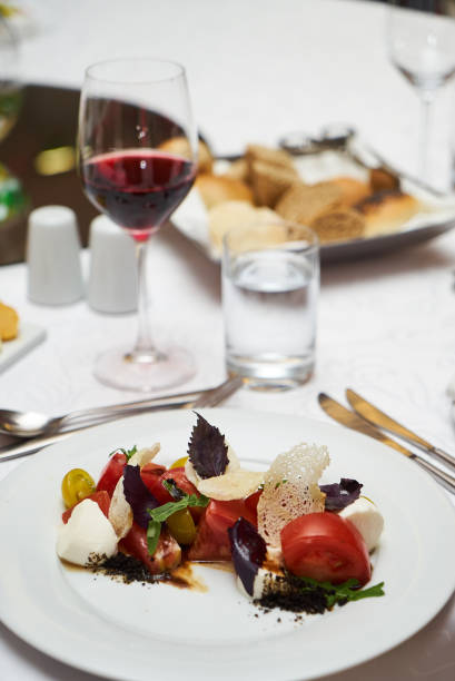 istock Vegetarian food with marinated tomatoes, arugula, mozzarella che 959740652