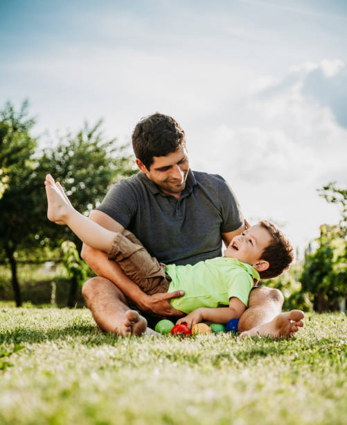 istock Father and baby boy playing together 959745284