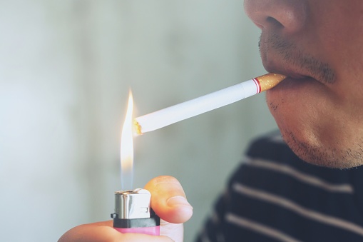 Close up of a man is inhaling smoking