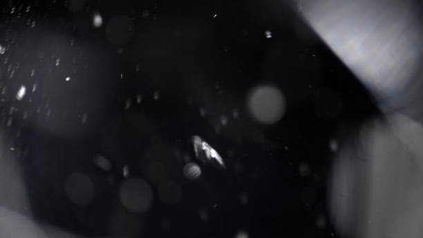istock Shattered and broken glass pieces isolated on black 959749318