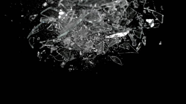 istock Shattered and broken glass pieces isolated on black 959749570