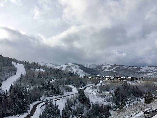 istock Road on snow mountain with cloudy sky 959750138