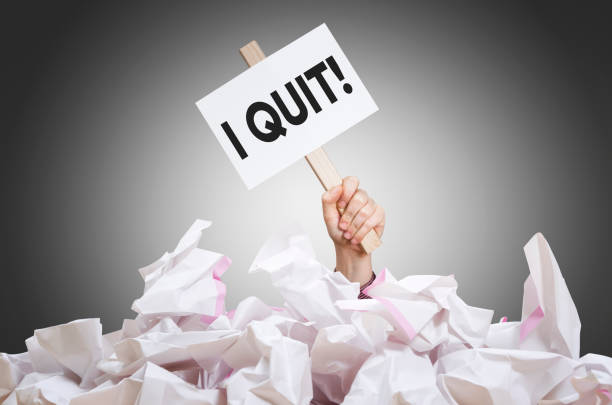 I quit! I quit placard in hand with crumpled paper pile quitting a job stock pictures, royalty-free photos & images