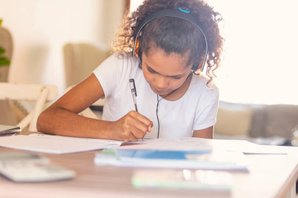 istock Young Aboriginal girl studying with headphones. 959754238