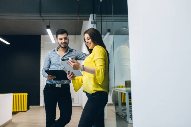 istock Two business people discussing business strategy using digital tablet 959754282