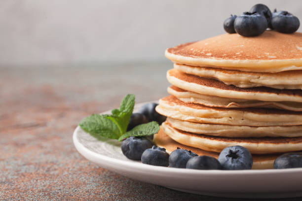 istock Delicious pancakes close up, with fresh blueberries, strawberries on a light background 959761204