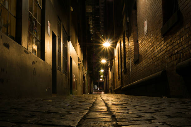 istock Dark alley way at night 959762674