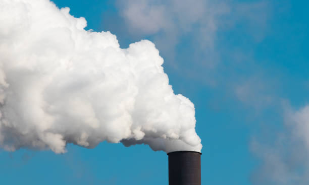 istock Steam and smoke coming out of a smoke stack 959765046