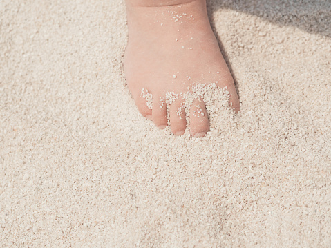baby foot in sands.
