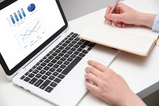 istock Close up of a person using white laptop at home office 959775844