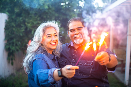 Senior Mexican Couple playing with sparklers