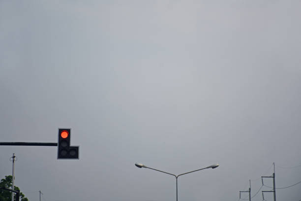 istock Traffic light at intersection roads show red light in twilight time 959780070