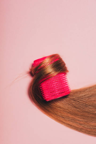 istock top view of hair rolled over curler on pink surface 959786496