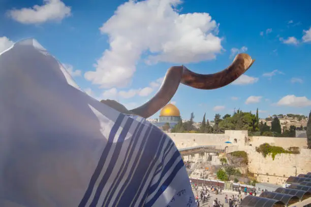 Man blowing shofar near the western wall in Jerusalem, Israel