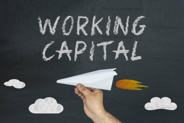 istock Working Capital concept with flying paper plane on blackboard 959801962