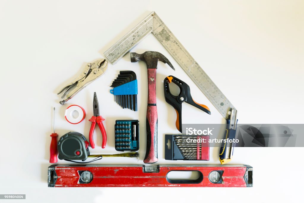 Home renovation concept. Shape of a house from construction tools. Home Improvement Stock Photo