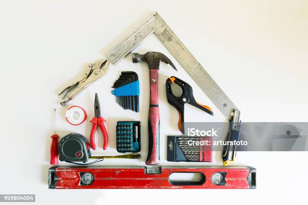 Home Renovation Concept Shape Of A House From Construction Tools Stock Photo - Download Image Now