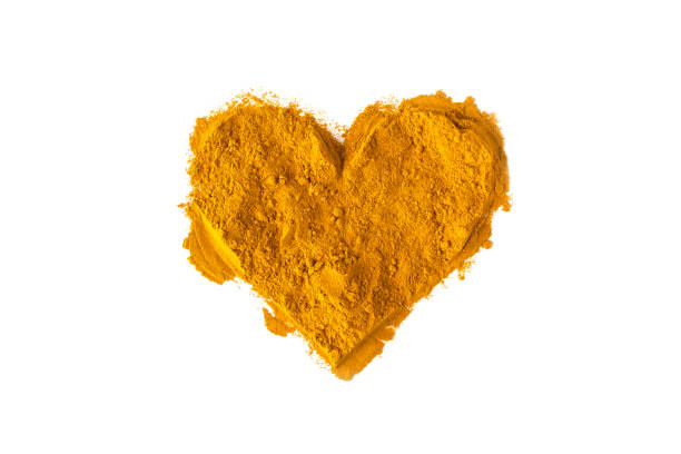 istock Turmeric powder in the shape of a heart. Isolated on white. Empty space for text or description. 959804198