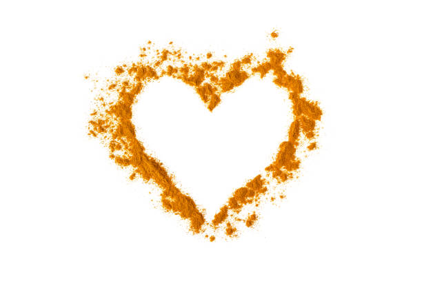 istock Turmeric powder in the shape of a heart. Isolated on white. Empty space for text or description. 959804816