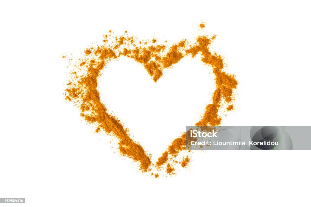 Turmeric powder in the shape of a heart. Isolated on white. Empty space for text or description. Turmeric Stock Photo